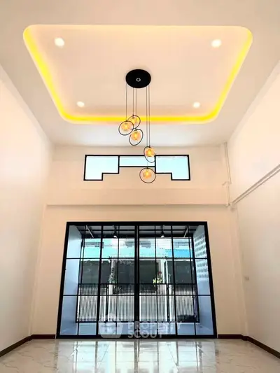 Spacious modern living room with high ceiling and stylish lighting