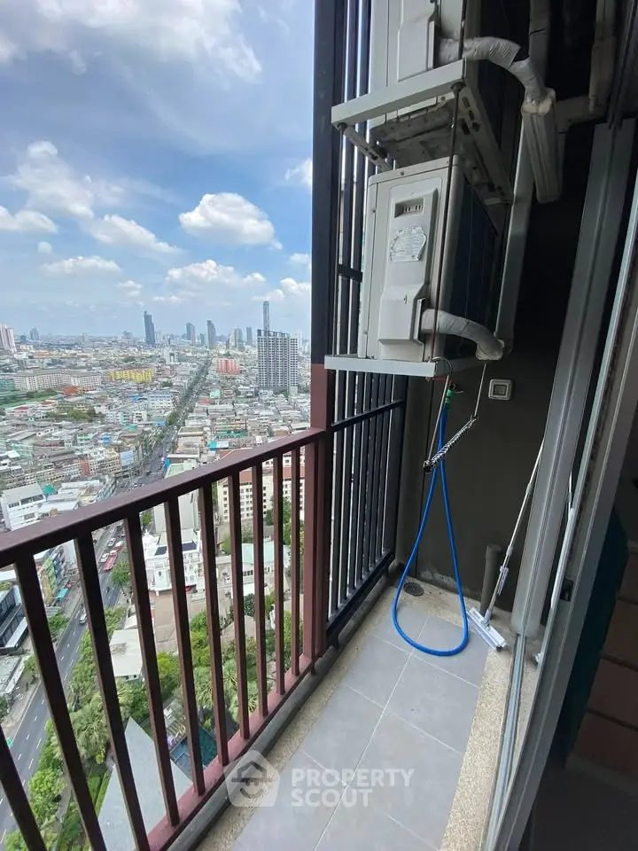 High-rise balcony with stunning cityscape view and air conditioning unit.