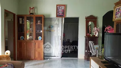 Cozy living room with wooden cabinet and decorative elements, perfect for family gatherings.