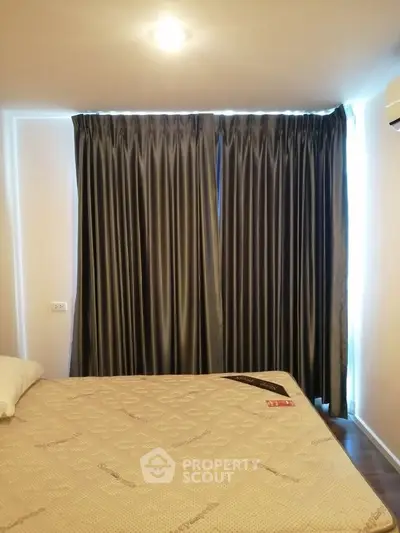 Cozy bedroom with elegant curtains and comfortable mattress