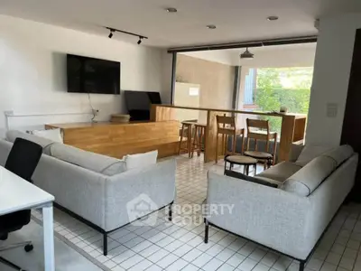 Modern open-plan living room with stylish furniture and natural light