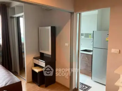 Modern apartment interior with compact kitchen and mirrored wardrobe