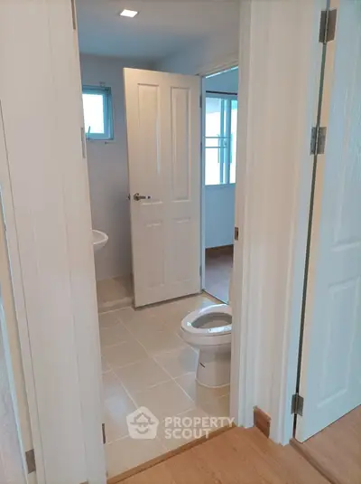 Modern bathroom with open door and natural light