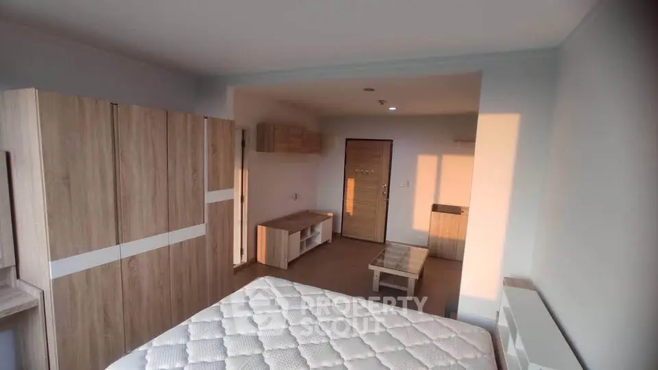Spacious bedroom with modern wooden furniture and natural light