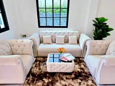 Elegant living room with plush sofas and chic decor, perfect for modern comfort and style.