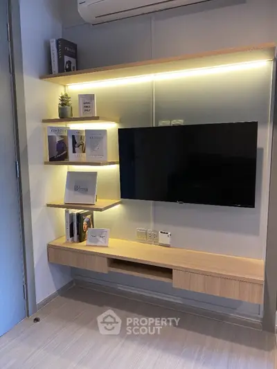 Modern living room with sleek TV setup and stylish shelving