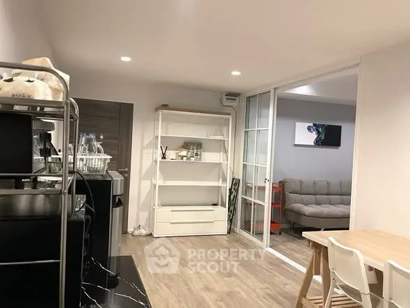 Modern open-plan living area with stylish furniture and wooden flooring