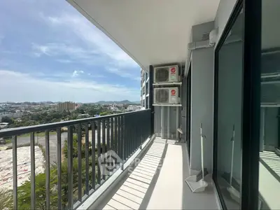 Spacious balcony with city view and air conditioning units, perfect for relaxation.