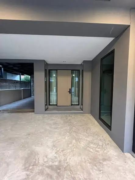 Modern entrance with sleek design and glass accents in a contemporary building.