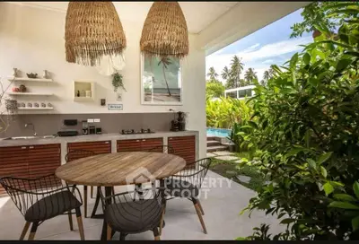 Charming outdoor kitchen with rustic dining set and lush garden view