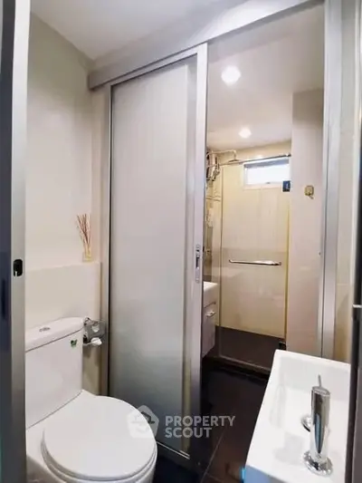 Modern bathroom with sliding door and compact design