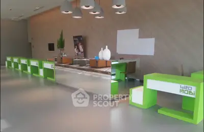 Modern real estate lobby with sleek green and white design, ideal for welcoming guests.