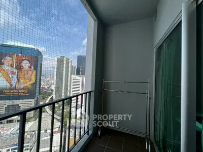 Urban balcony with city view and metal rack, perfect for enjoying skyline vistas.