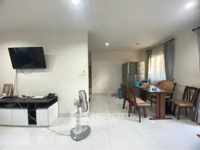 Spacious living area with modern furniture and natural light, perfect for family gatherings.