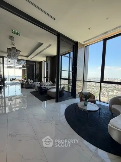 Luxurious high-rise living room with panoramic city views and elegant modern furnishings.