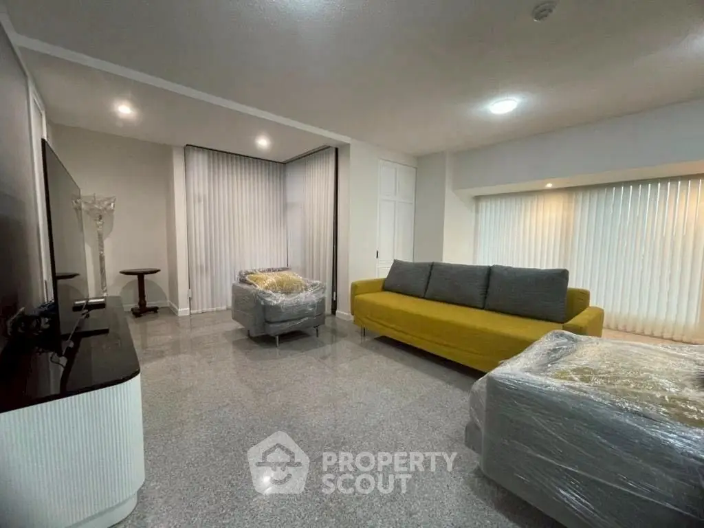 Spacious modern living room with stylish furniture and sleek flooring