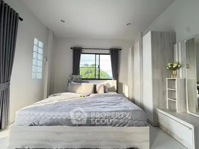 Modern bedroom with stylish decor and ample natural light