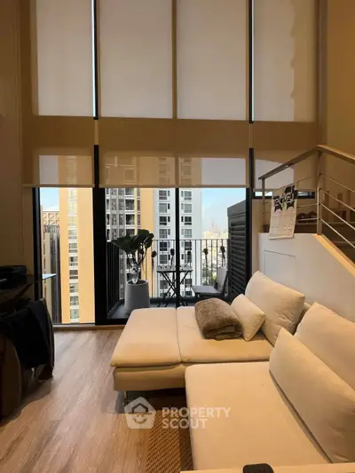 Modern living room with high ceilings and balcony view in luxury apartment
