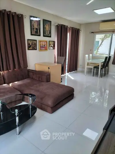 Spacious living room with modern furniture and large windows for natural light.