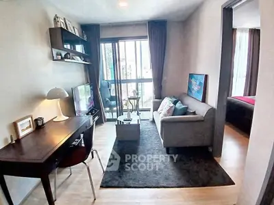 Modern living room with cozy sofa, study desk, and balcony view in stylish apartment.