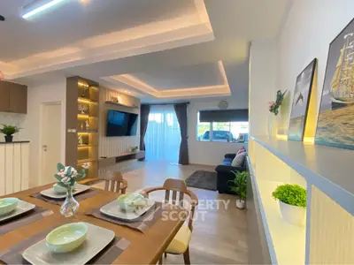 Modern open-plan living and dining area with stylish decor and ambient lighting.