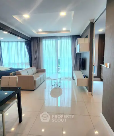 Modern living room with sleek design and large windows offering natural light