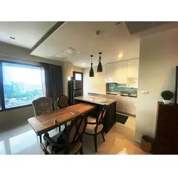 Modern open-layout kitchen with dining area and large window view