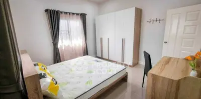 Bright and cozy bedroom with modern furniture and ample natural light.