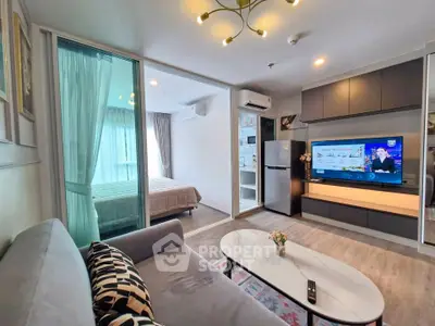 Modern living room with open layout, stylish decor, and a view into a cozy bedroom.
