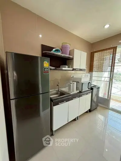 Modern kitchen with sleek appliances and ample natural light
