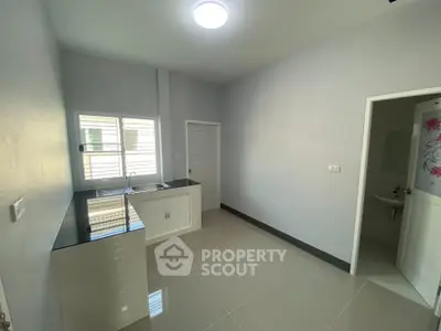 Spacious modern kitchen with sleek countertops and ample natural light.