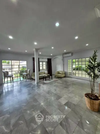 Spacious living room with modern decor and large windows for natural light.