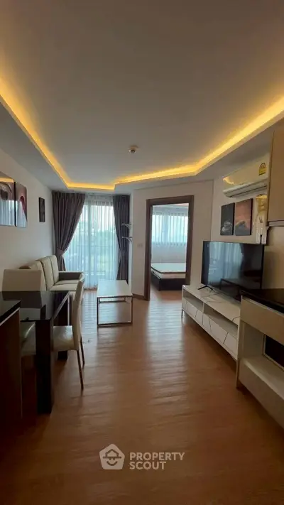 Modern open-plan living room with elegant lighting and stylish decor