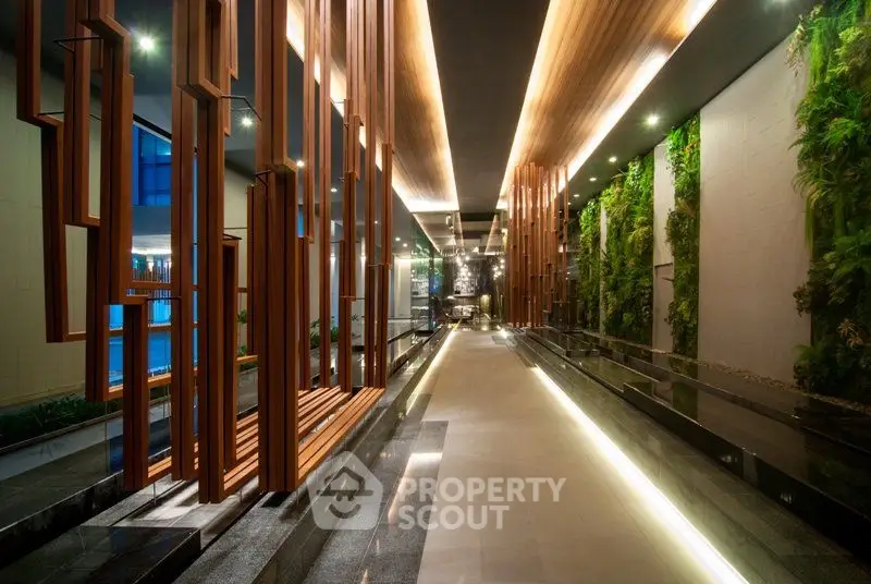 Luxurious modern building entrance with elegant wooden accents and vertical garden walls.