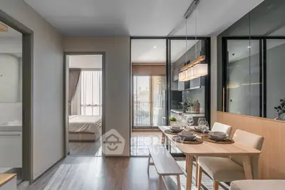 Modern dining area with elegant table setting and view into cozy bedroom
