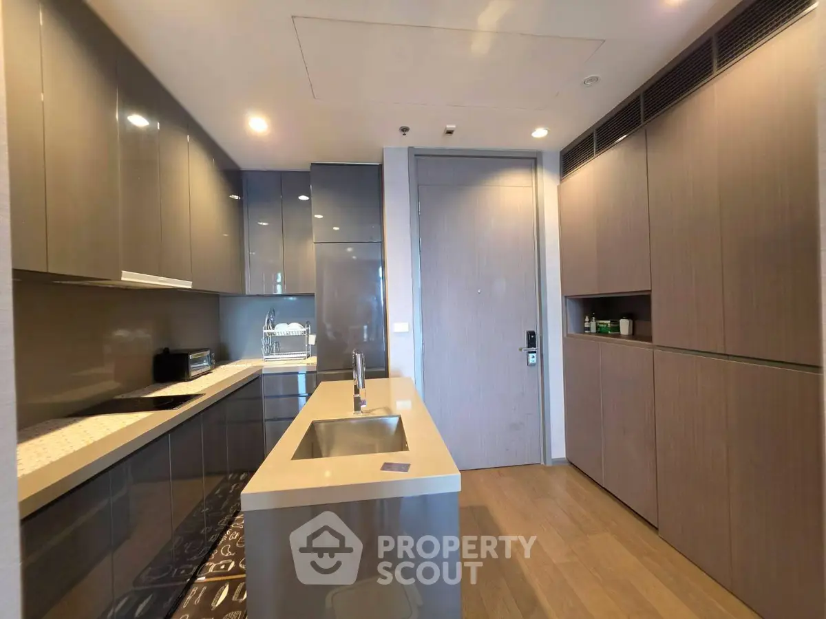 Modern kitchen with sleek cabinetry and island in luxury apartment