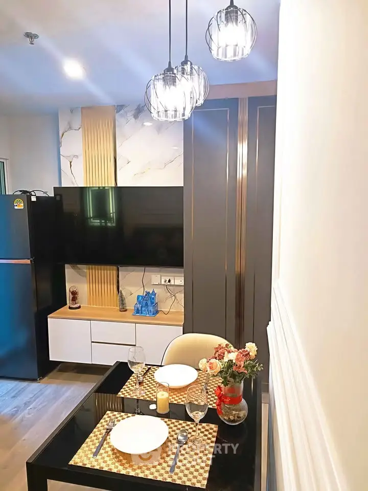 Modern dining area with elegant lighting and stylish decor in a contemporary apartment.