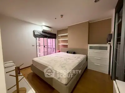 Spacious bedroom with modern furnishings and balcony access in a stylish apartment.