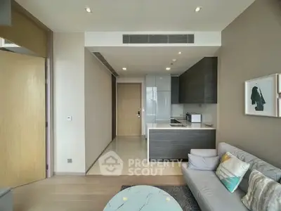 Modern living room with open kitchen layout and stylish decor