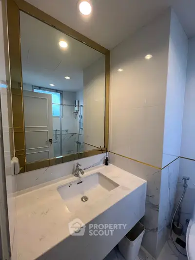 Modern bathroom with elegant marble sink and large mirror