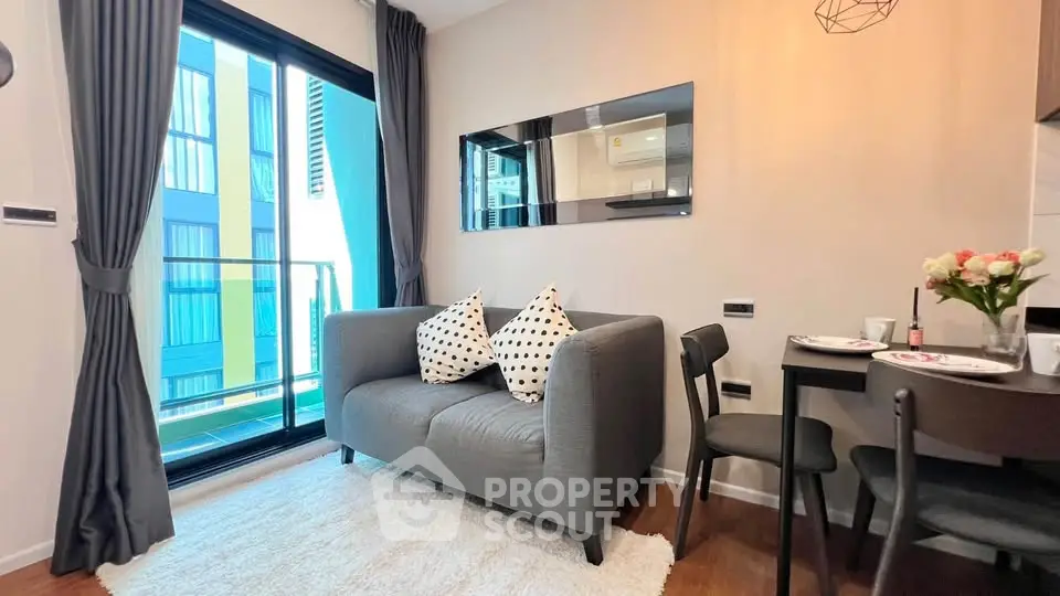 Modern living room with cozy sofa, dining area, and balcony view in stylish apartment.