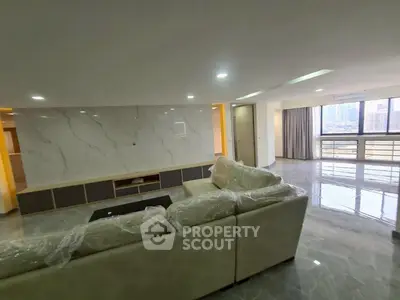 Spacious modern living room with marble accents and city view