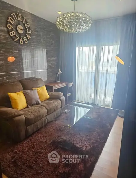 Stylish living room with modern decor, plush sofa, and large window for natural light.