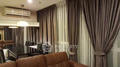 Luxurious living room with elegant curtains and modern dining area