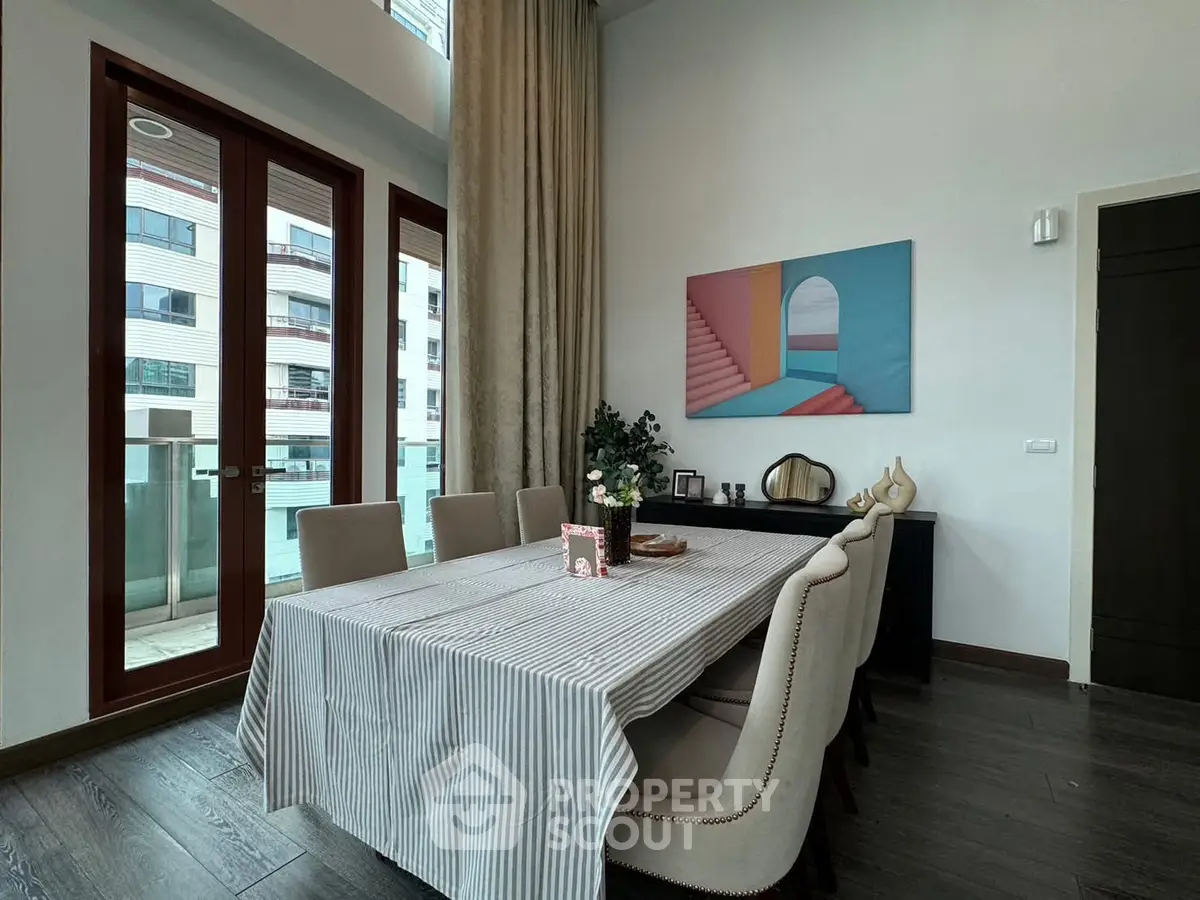 Elegant dining area with modern decor and large windows offering natural light.