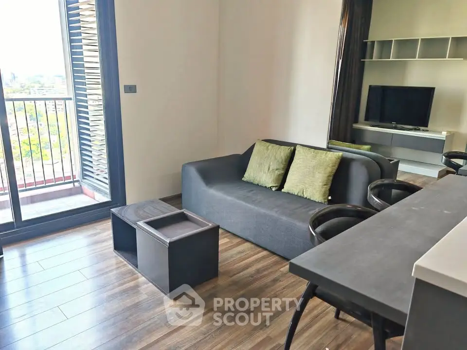 Modern living room with balcony view and stylish furniture in urban apartment