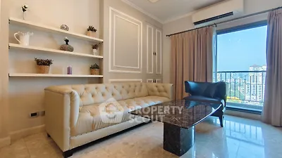 Luxurious living room with elegant sofa and stunning city view from large window.