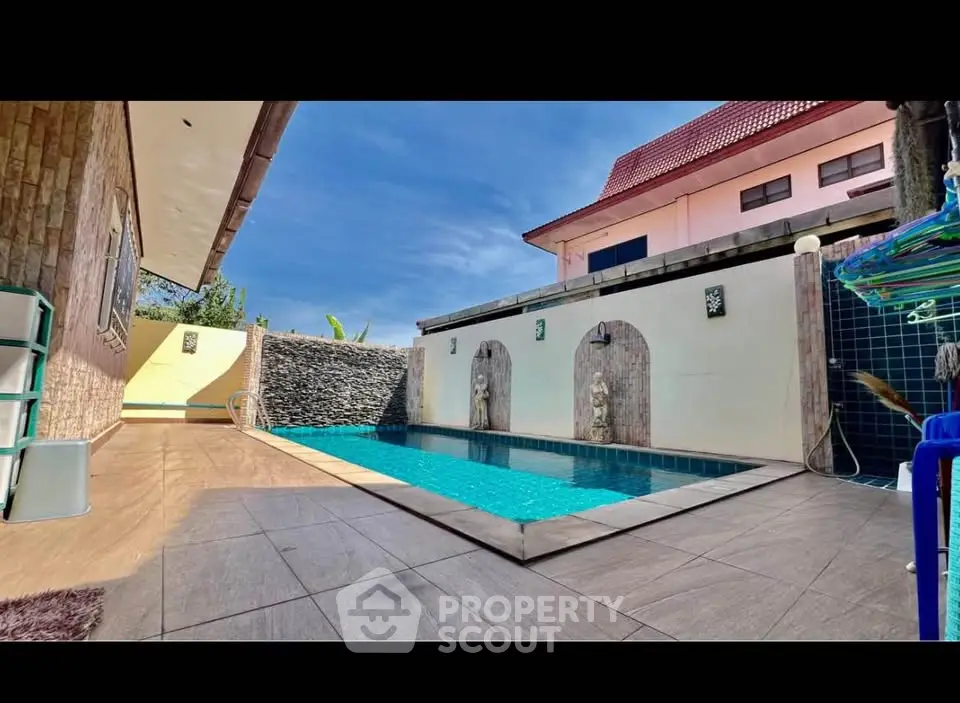 Luxurious private pool area with elegant stone wall and serene atmosphere