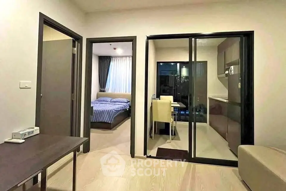 Modern apartment interior with open kitchen and cozy bedroom view