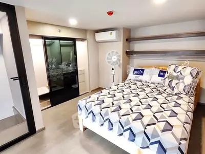 Modern bedroom with geometric bedding and built-in storage